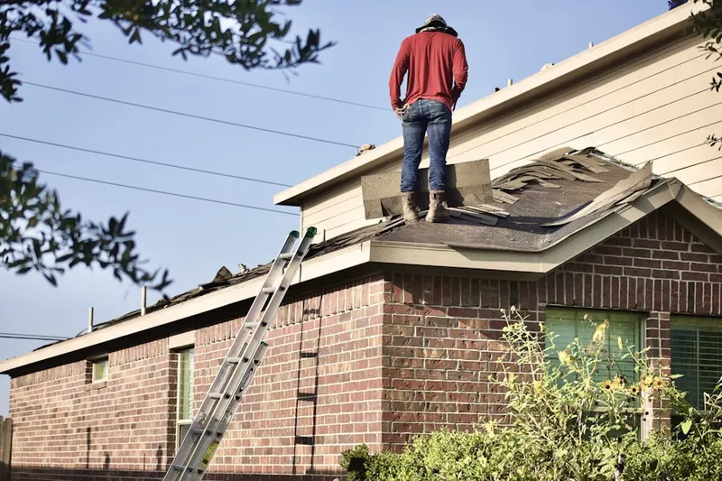 Professional roofer working on a residential roof in Lenexa